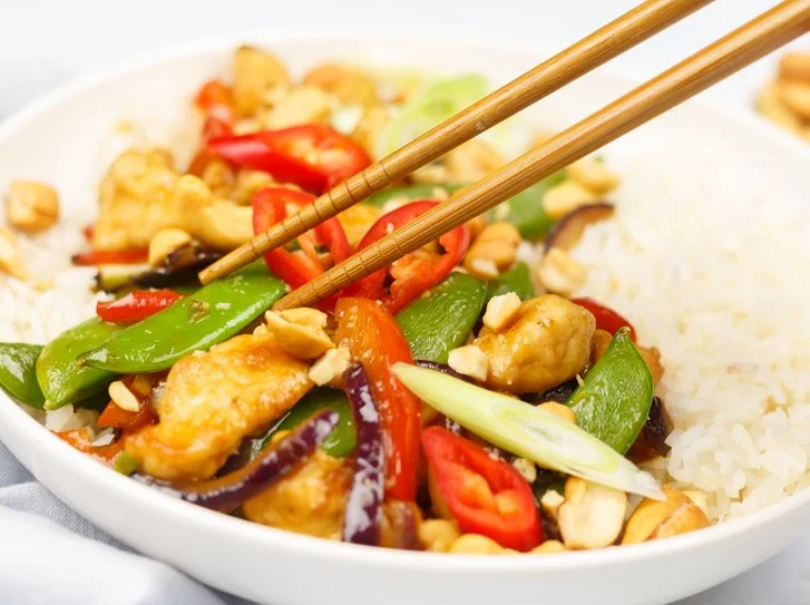 A colorful plate of Chicken Siam, showcasing tender chicken and vibrant spices.