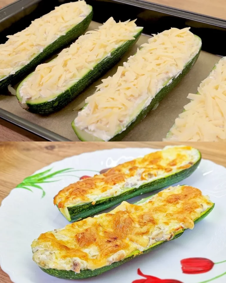 Gevulde courgette schepen met romige champignon en kaas vulling, geserveerd op een wit bord.