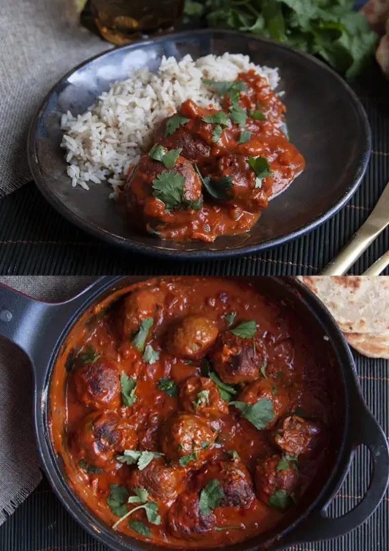 Indiase gehaktballetjes in aromatische Madras kokos saus op een bord.