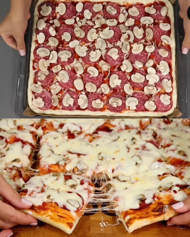 Klassieke zelfgemaakte pizza met salami, champignons en mozzarella op een houten plank.