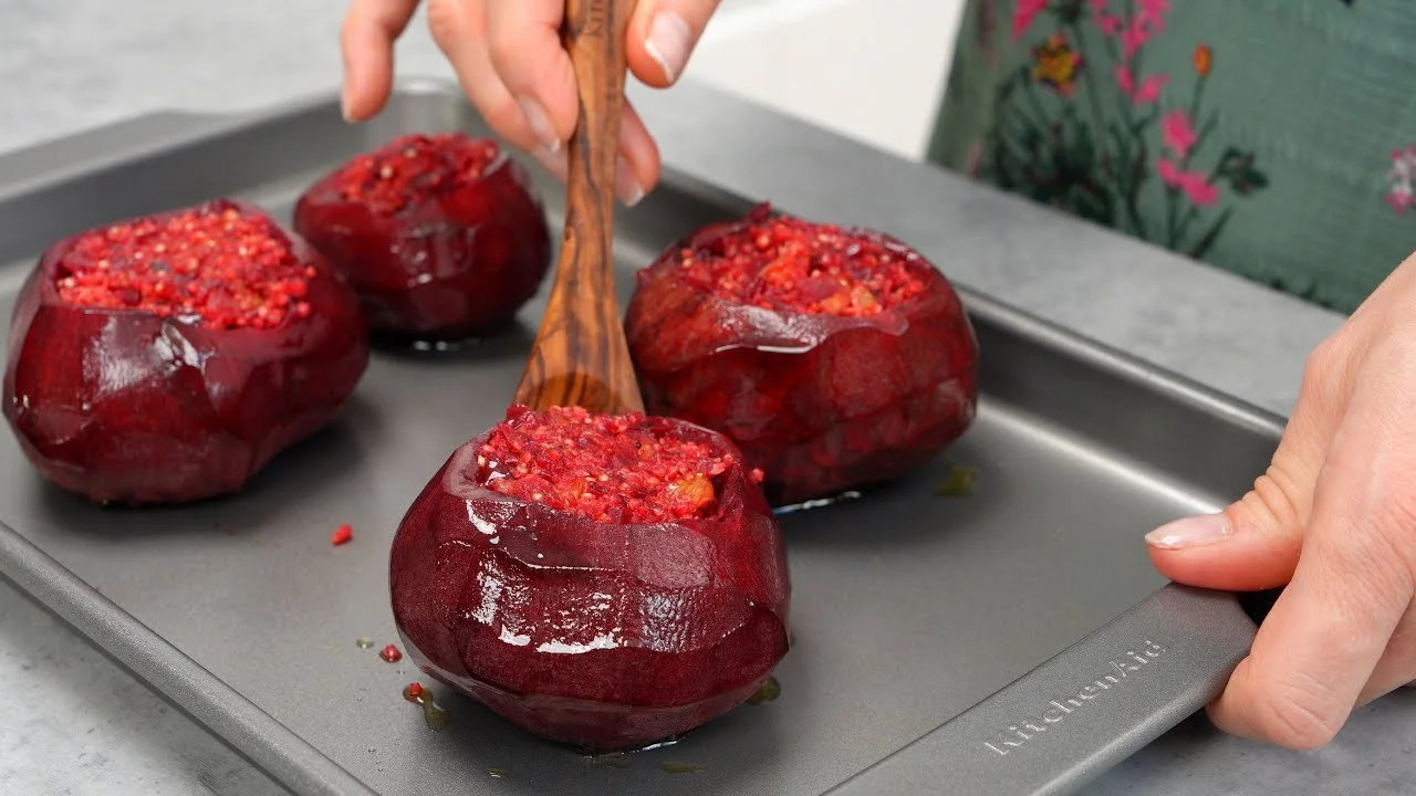 Gevulde biet met walnoot, quinoa en tahinisaus op een bord